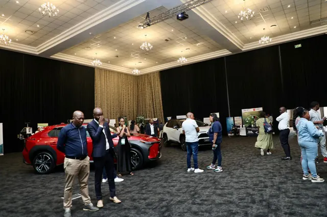 Delegates viewing electric vehicles on display at the Indaba exhibition hall